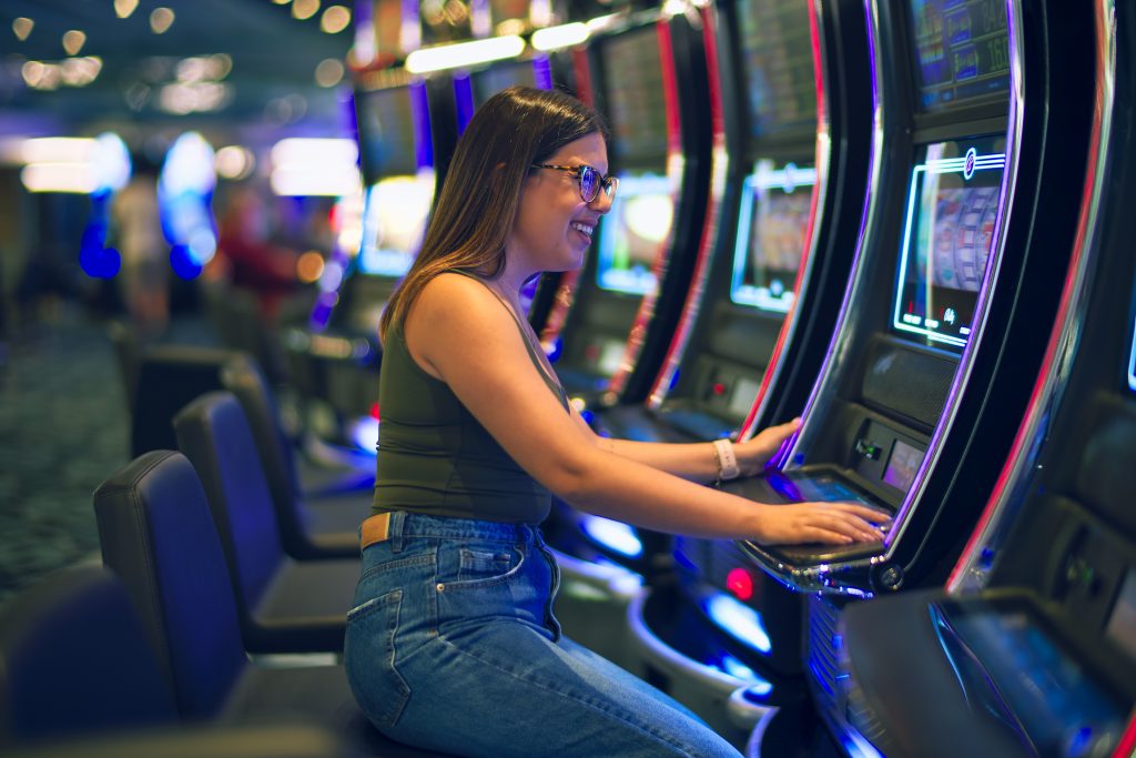 A cruise ship casino guest enjoying playing the slots